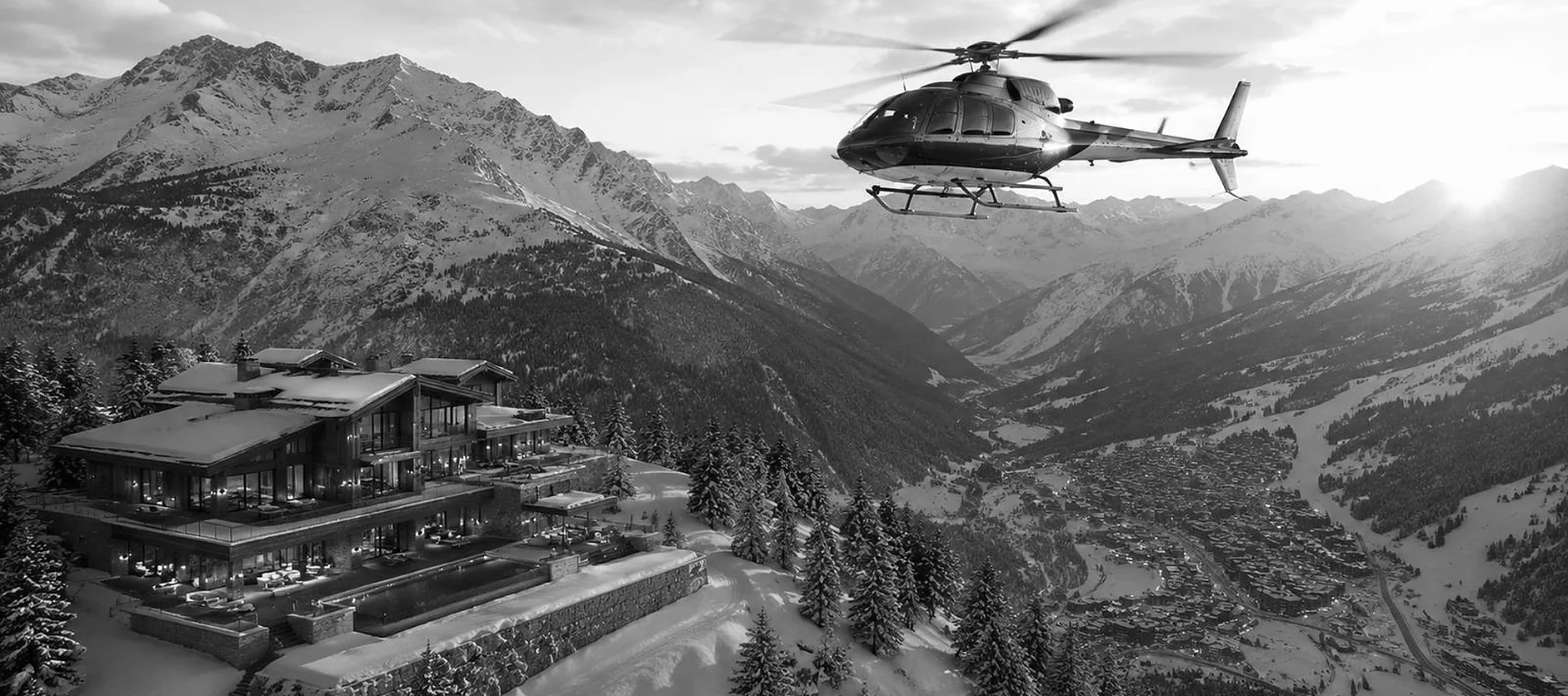 Luxury chalet rental in the Alps with a private helicopter over the valley