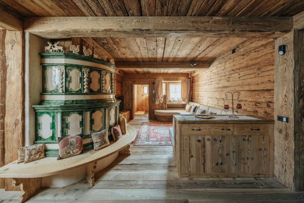 Casa Aurea, Cortina d'Ampezzo — carved timber passage beside the stube