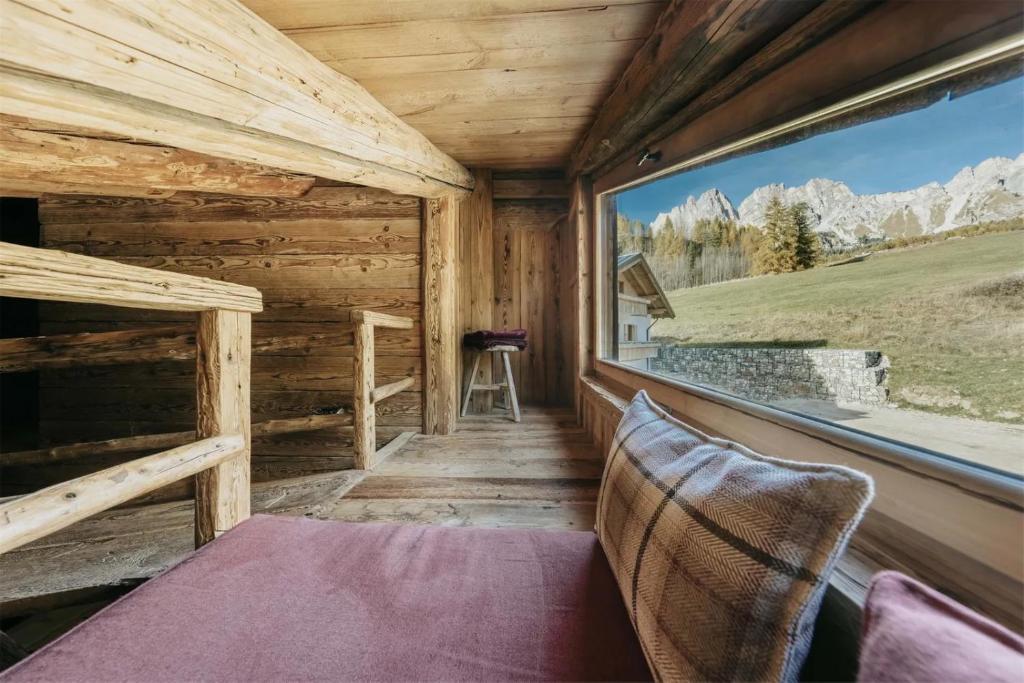 Casa Aurea, Cortina d'Ampezzo — panoramic window framing the Dolomite peaks
