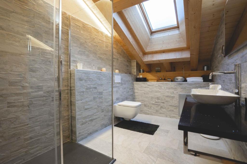 Chalet Talisman, Zermatt — bathroom with stone walls and vanity